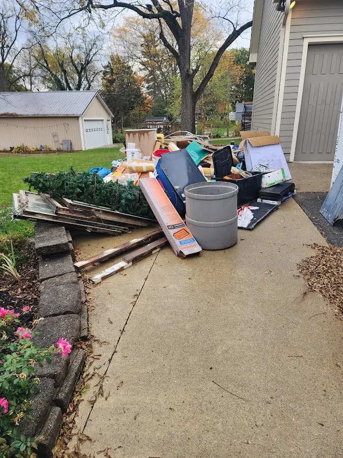 Dumpster being loaded with debris for Commercial Dumpster Rental in Long Branch